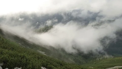 High top of the mountain with fast moving clouds. sunset after the rain. smooth Stock Footage 77549656