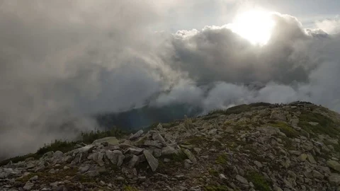 High top of the mountain with fast moving clouds. sunset after the rain. smooth Stock Footage 77555305