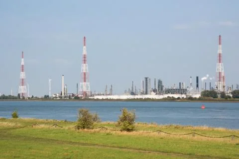 High torches in front of a refinery Stock Photos