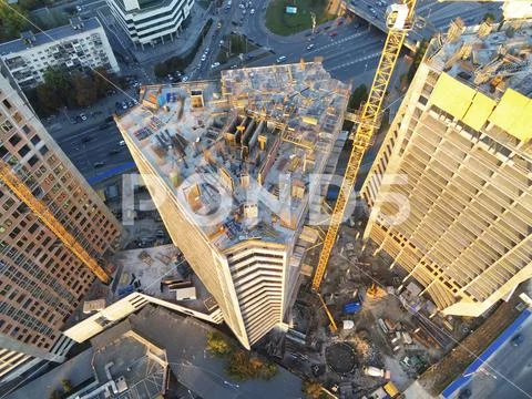 High tower building construction site. Bug industrial crane. Aerial drone view Stock Photos