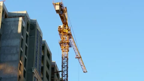 High tower crane for house building at the construction site on sky background Stock Footage 265247171