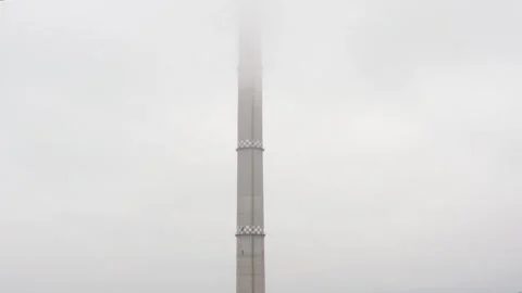 High tower of factory reaching the clouds Stock Footage 257894181