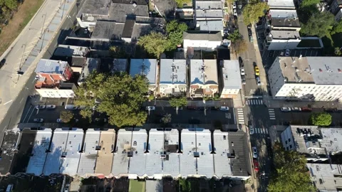 High vantage drone view exposing Jersey City’s compact housing grid, tree-lined Stock Footage 321883228