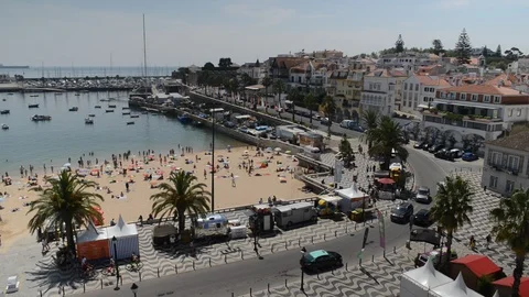 High vantage point of crowded sandy Praia do Ribeiro, Cascais, Portugal Stock Footage 94121811