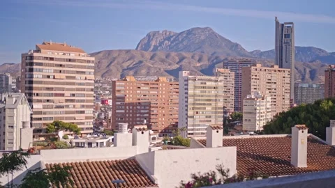 High view of Benidorm buildings and mountains during the day, showing urban life Stock Footage 337151938