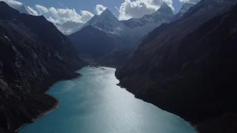 High view Camera panning down along blue water of Laguna Peron from Snow cap Stock Footage 252376886