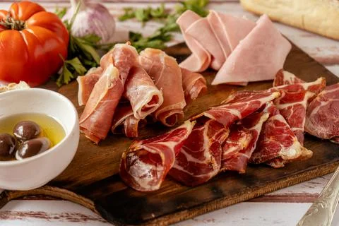 High view of a Delicious table of serrano ham, cooked ham and pickled pork bu Stock Photos