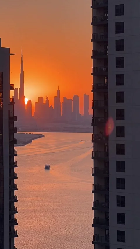 High view of Downtown Dubai skyline at sunset, with the Dubai Creek canal Stock Footage 311200677