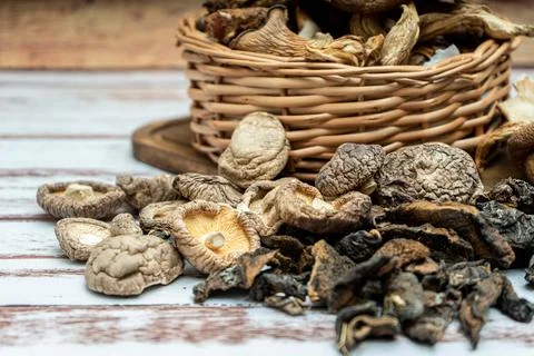 High view of dried pine, shiitake and oyster mushrooms in a wicker basket on  Stock Photos