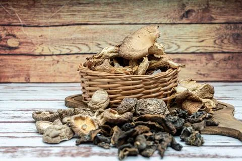 High view of dried pine, shiitake and oyster mushrooms in a wicker basket on  Stock Photos