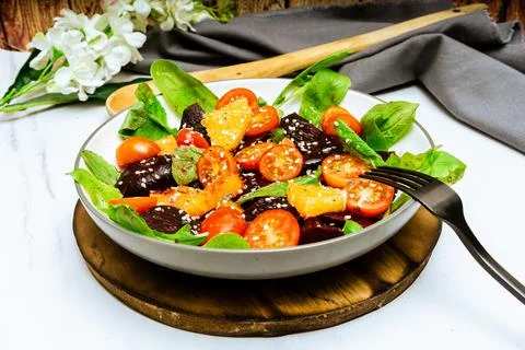 High View of exquisite salad of beetroot, orange, cherry tomato and arugula w Stock Photos