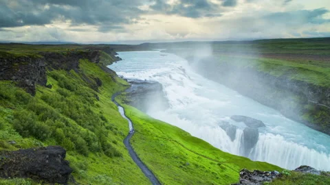 Up-high view of giant waterfall flowing in Iceland mountains. Stock Footage 140348936