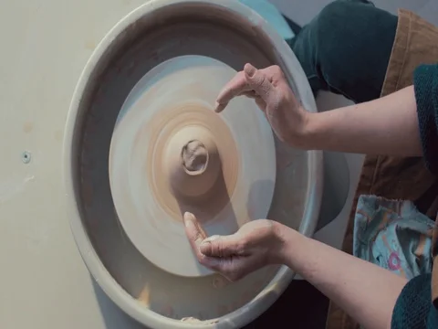 High view of Hands of Potter and A Spinning Pottery Wheel Stock Footage 72279291