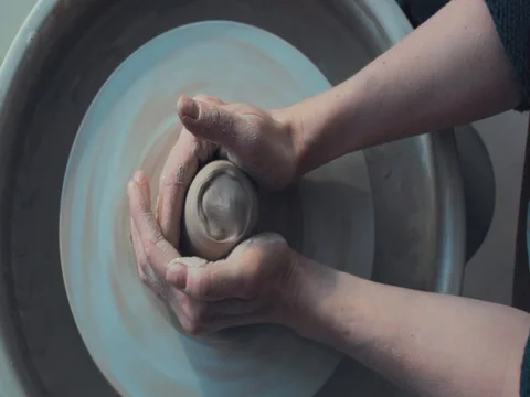 High view of Hands of Potter and A Spinning Pottery Wheel Stock Footage 72279447