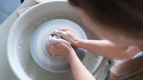 High View Of Hands Of Potter And A Spinning Pottery Wheel Vidéo 169227306