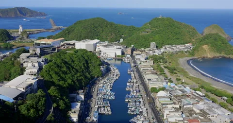 A high view from the sky of a small town beside the ocean. Stock Footage 213757620