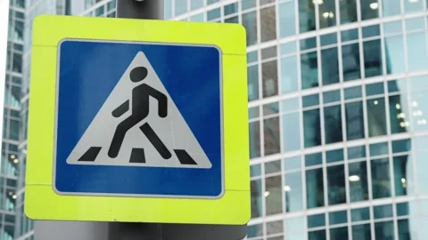 High-visibility pedestrian crossing sign with blue triangular symbol and zebra Stock Footage 327730153