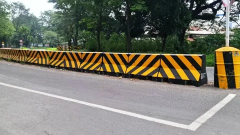 High Visibility Road Barrier with Black and Yellow Chevron Safety Markings Stock Footage 332601517