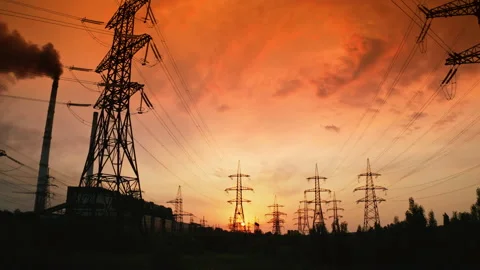 High voltage cable and pylons at sunset. Silhouettes of electric towers against  Stock-Footage 156663739