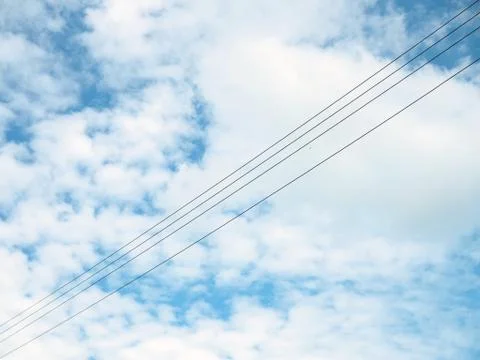 The high voltage cable on the background is an empty blue sky.Minimal concept. Stock Photos