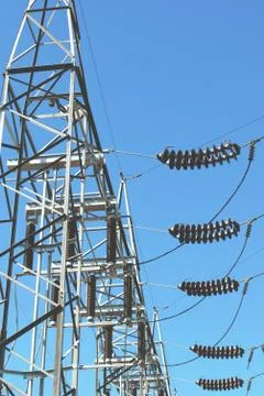 High voltage ceramic electrical insulators at a power station. Low angle shot. Photos