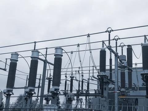 High-Voltage Ceramic Insulators and Power Lines at an Electrical Substation Stock Photos