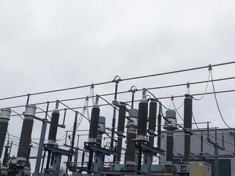 High-Voltage Ceramic Insulators and Power Lines at an Electrical Substation Stock Photos