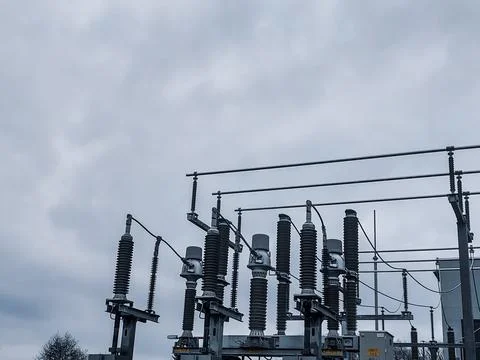 High-Voltage Ceramic Insulators and Power Lines at an Electrical Substation Stock Photos