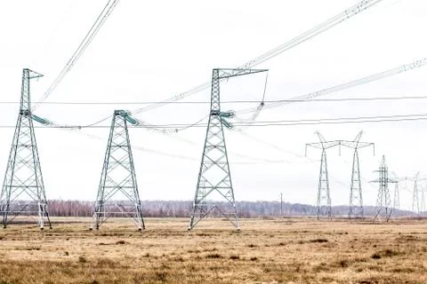 High-voltage column. High-voltage poles against a cloudy sky background Stock Photos