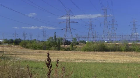 High voltage electric distribution lines on pylons at countryside. Stock Footage 117540278