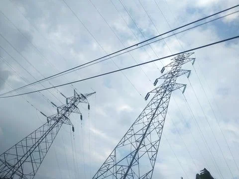 High voltage electric pole with cloudy sky Stock Photos