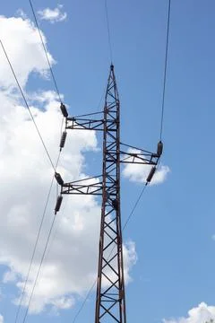 High voltage electric pole set as one of many on the entire length of the Stock Photos