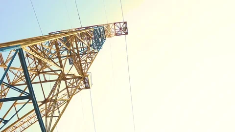 High-voltage electric support coming from the power station with wires against Stock Footage 106997536