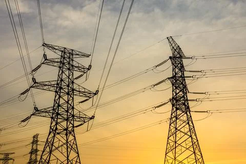 High voltage electric tower at sunset. Stock Photos