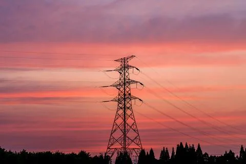 High voltage electric tower at sunset. Stock Photos