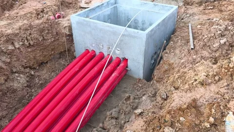 High Voltage Electrical Cable HDPE Pipe Installation in Construction Trench Stock Footage 340986003