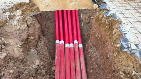 High Voltage Electrical Cable HDPE Pipe Installation in Construction Trench Stock Footage 340986096