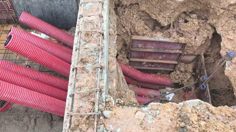 High Voltage Electrical Cable HDPE Pipe Installation in Construction Trench Stock Footage 340986146