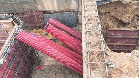 High Voltage Electrical Cable HDPE Pipe Installation in Construction Trench Stock Footage 340986184