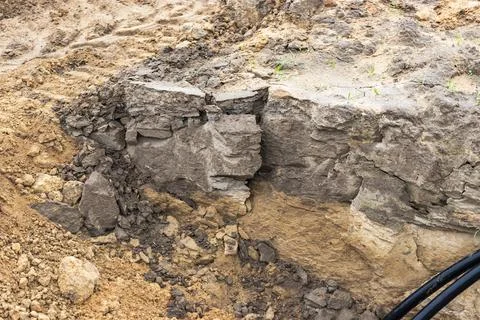 The high voltage electrical cable is laid in a trench under existing engineer Stock-Fotos
