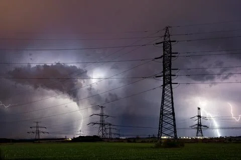 High voltage electrical mast with lightning storm over Prague, Czech republic Stock Photos