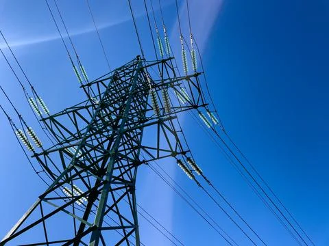 High voltage electrical network against blue sky background. Stock Photos