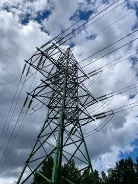 High voltage electrical network with cloudy sky. Stock Photos