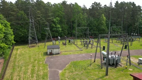 High Voltage Electrical Network with Transformers in Forest Landscape Stock Footage 336550292