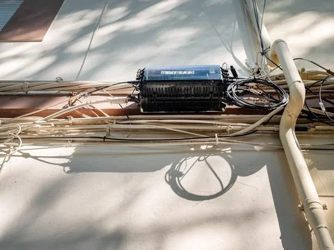 High voltage electrical power cables, telephone and internet cables in fron.. Stock Photos