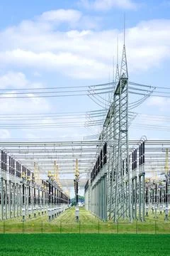 High voltage electrical power grid substation against blue sky Stock Photos