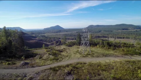 High Voltage electrical power line in mountain hills area Stock Footage 42950296