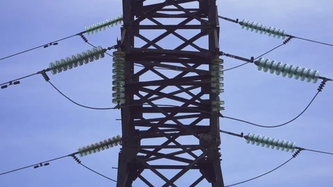 High-voltage electrical pylons against a blue sky Stock Footage 105637063