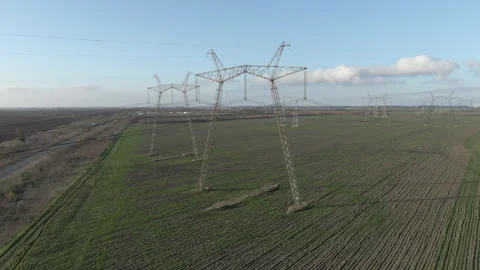High-voltage electrical pylons  in the field. Aerial view. Stock Footage 309564984