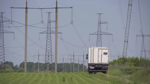 High-voltage electrical pylons  in the field Stock Footage 318549942